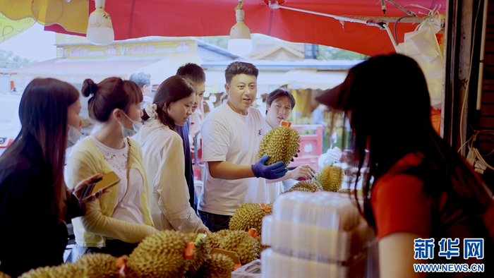 昆明金马正昌果品批发市场，顾客正在挑选榴莲（7月22日摄）。新华网发（鲁彬 摄）